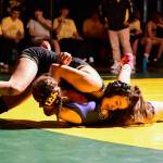 Kyla Scheff works to achieve a fall in a home dual meet. (Tony Puz photo)