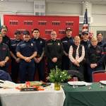 Staff of Vashon Island Fire Rescue surround Matt Vinci (center) on Friday, after a luncheon on his last day as Vashons fire chief. Deputy Chief Ben Davidson (second from right) now leads the district. (Elizabeth Shepherd photo)