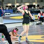 Lena Puz celebrates her win over South Whidbeys Kaylie Baker at the Mat Classic state wrestling championships. (Tony Puz photo)