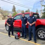 (Left to right) Interim Fire Chief Ben Davidson, Lieutenant Josh Lawson and Captain Josh Munger all responded to calls during a wild wind storm last week. This photo, with one of the districts generators, was taken the day after the storm. (Elizabeth Shepherd photo)