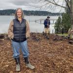 Leslie Brown photo
Jane Slade is pleased with her property's transformation. Behind her, a Washington Conservation Corps crew installs native plants. All told, 370 native shrubs, grasses and wildflowers were planted. 