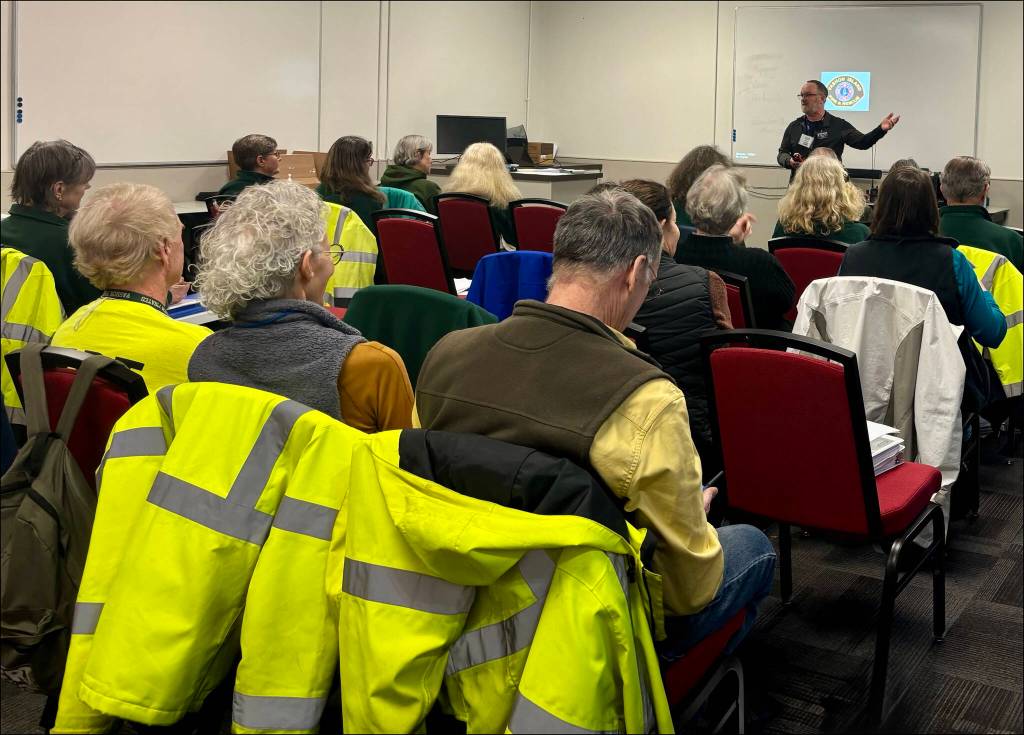 In this CERT photo, Michael Meyer from Vashons Auxiliary Communication Service (ACS) teaches best practice procedures to conduct clear emergency radio communications in the field. (MJ Witt photo)