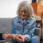 Alex Bruell photo
Grannys Attic volunteer Vicki Clabaugh smiles while holding the arm of Holly Beemer, who is wearing a bracelet of family names which she accidentally donated to the island thrift store while moving several months ago.