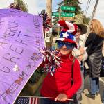 Elizabeth Shepherd Photo
One colorfully-clad islander showed up in red, white, blue, with a message on her purple umbrella: Hate never made America great.