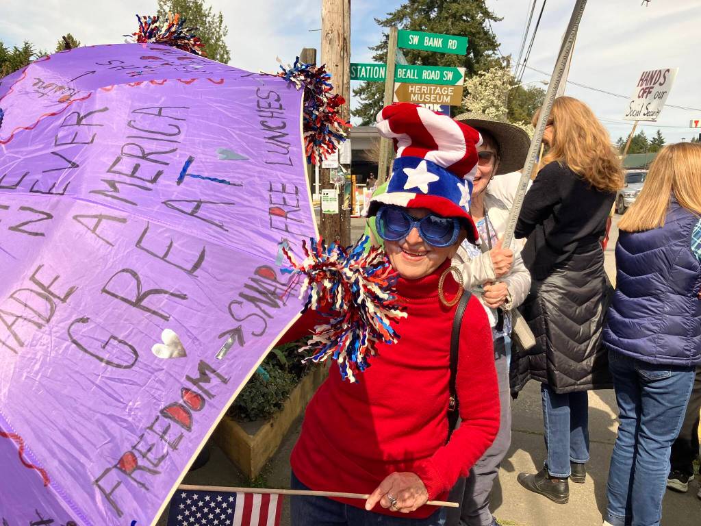 Elizabeth Shepherd Photo
One colorfully-clad islander showed up in red, white, blue, with a message on her purple umbrella: Hate never made America great.