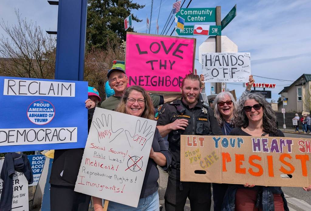 Ina Gylys-Colwell photo
A King County sheriffs deputy, who helped tamp down tensions at one point as a person argued with protestors, is pictured at the protest Saturday.