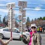 Alex Bruell photo
Carol Goertzel (left) and Karol Lake held broomsticks affixed with signs reading HANDS OFF! followed by a list of services at the Saturday protest.