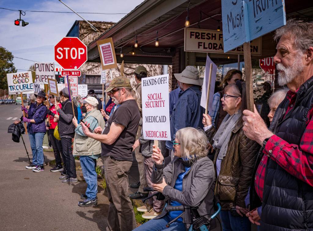Kent Phelan photo
Demonstrators took to the side walks around Vashon Highway at the towns four-way stop to protest the Trump administration.