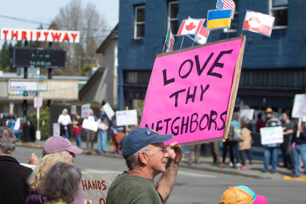 Alex Bruell photo
A sign affixed with the flags of other countries reads LOVE THY NEIGHBORS at the demonstration.
