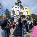 Elizabeth Shepherd Photo
Islanders lined the four-way interesection in the center of town on Saturday, with some standing by another sign of the times: an recently placed sandwich board advising Vashon residents what to do if they see immigration and customs enforcement officers on the island.