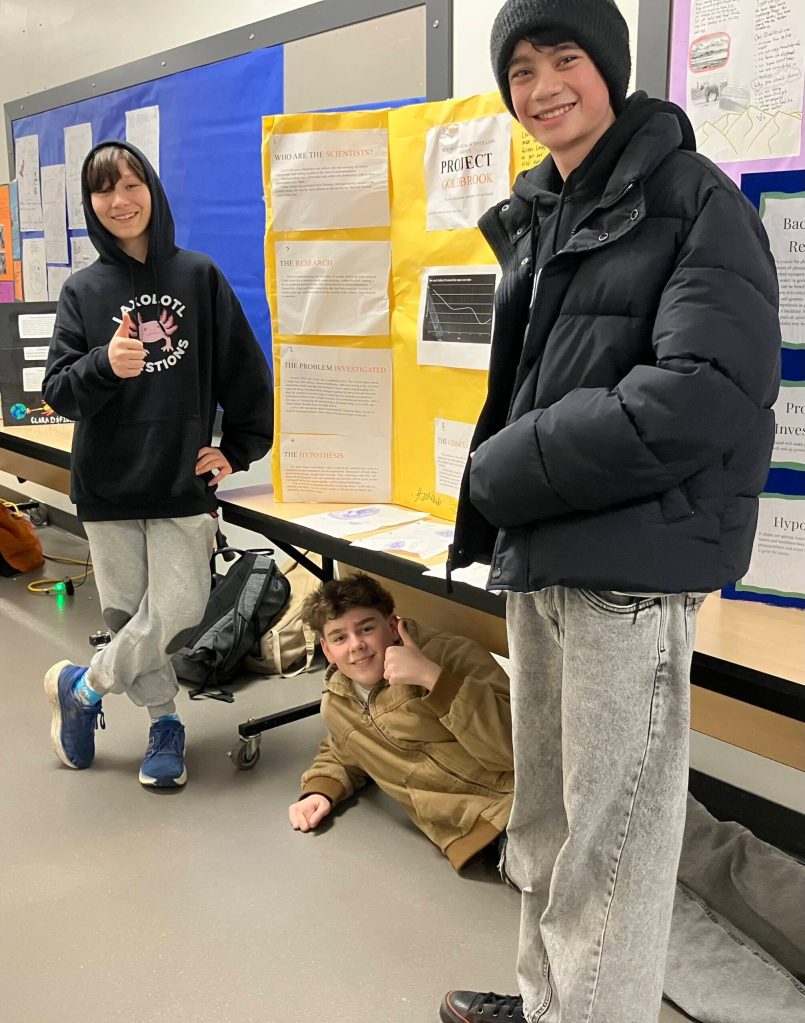 (Left to right) Oskar Salem, Desmond Berg, and Levi Cobb show off Project Goldberg. (Elizabeth Shepherd photo)