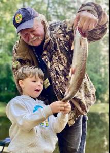 Prescott Jackson is awed by his catch from the Sportsmens Club Pond at a previous trout derby. The Vashon Sportsmens Club will host its annual Kids Trout Derby starting at noon on Sunday, May 18. (Courtesy photo)