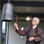 Shuko Johannessen of the Puget Sound Zen Center rings a bell as each name of a family exiled from Vashon is read. Of the 30 families exiled, only 12 returned to Vashon after the war. (Jim Diers photo)