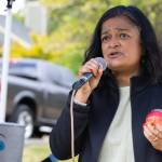 U.S. Rep. Pramila Jayapal, holding an apple, celebrated the groundbreaking as an example of the beautiful, loving spirit of the island. (Alex Bruell photo)