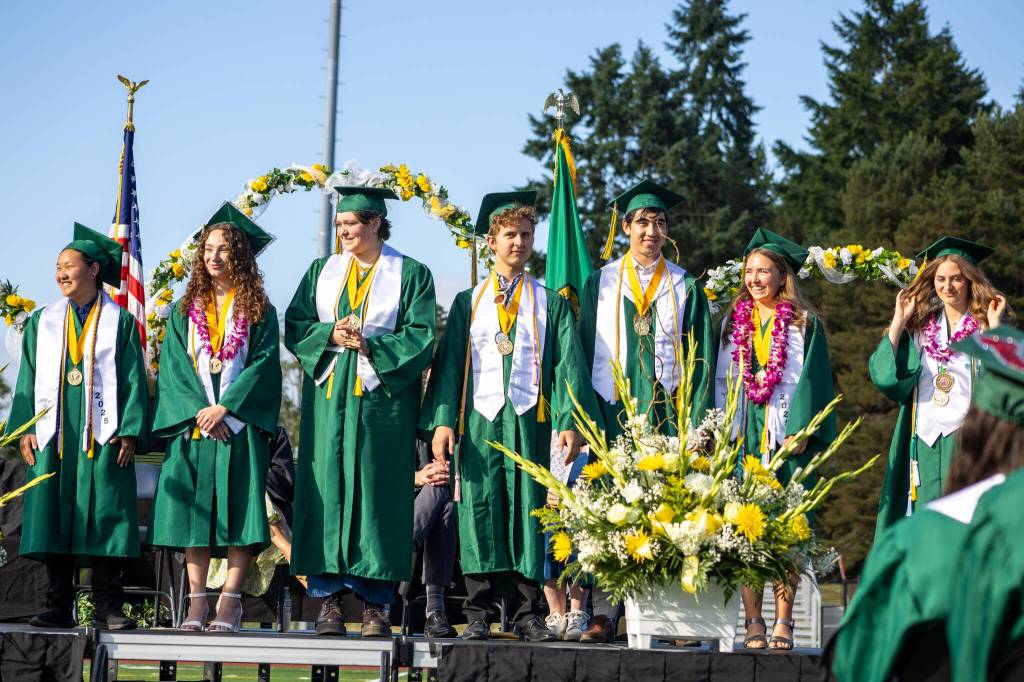Valedictorians Gracie Beggs-Ruegamer, Natalie Vickers, Haley Hopper, Rowan McBennett, Forest Macnab, Laurel Calhoun and salutatorian Kyla Scheff were honored for their academic achievements. (Alex Bruell photo)