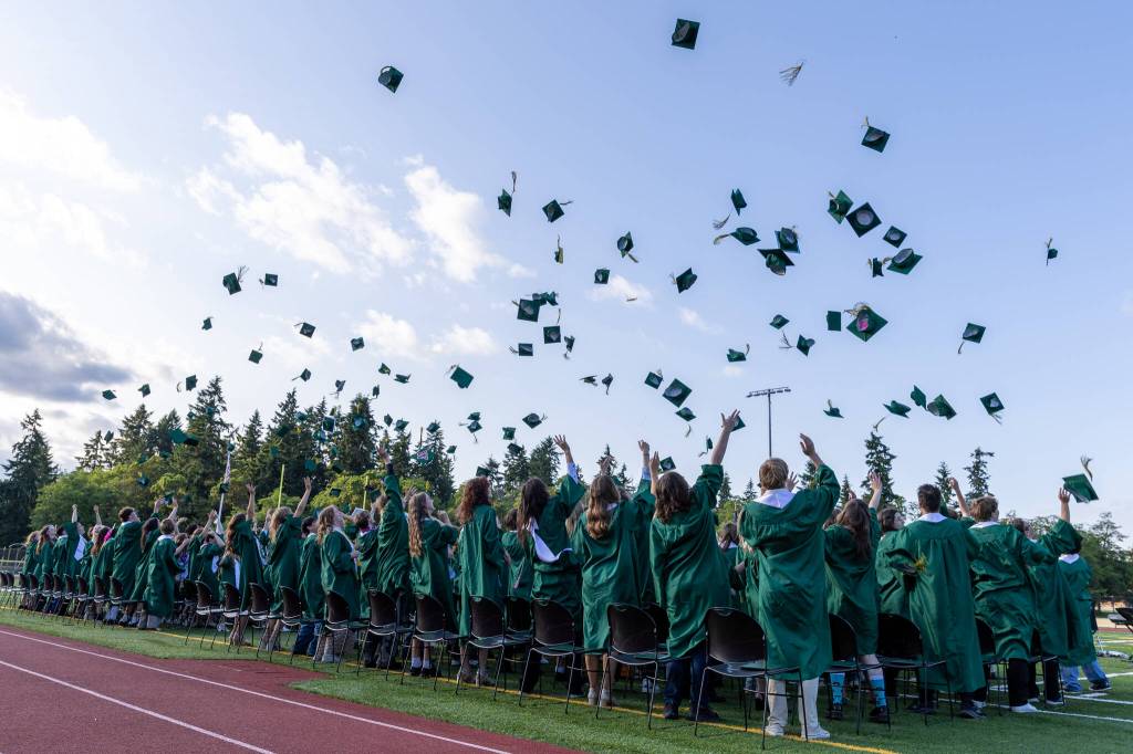 Graduates toss their caps into the air at the close of the ceremony. (Alex Bruell photo)