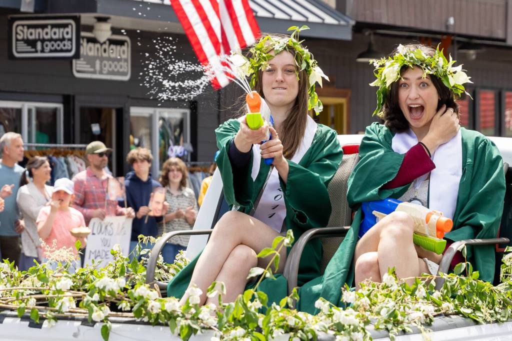 Graduates splash the crowds during the VHS graduation parade. (Alex Bruell photo)