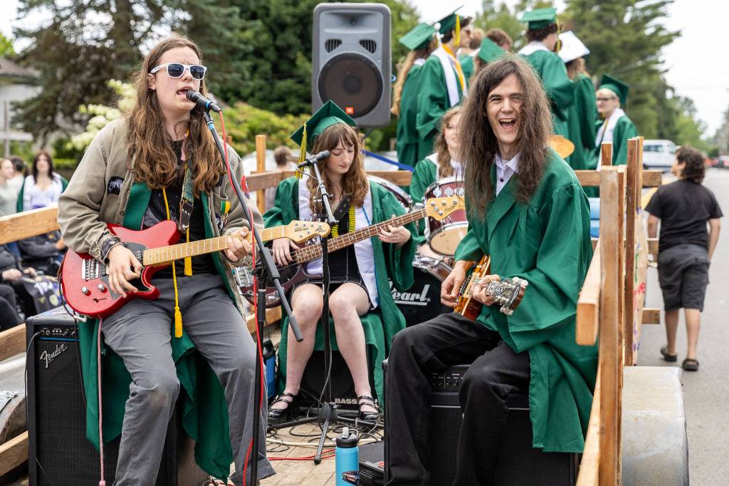 Graduates rock out to Weezers self-titled debut album in a mobile concert during the graduate parade. (Alex Bruell photo)
