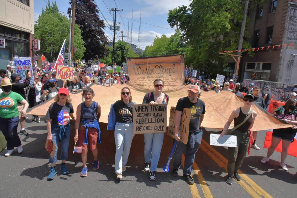 A No Kings protest in Seattle included this large depiction of the U.S. Constitution, crafted by Vashon artists and carried by members of Vashons Backbone Campaign. A similar copy was carried in Los Angeles. (Jim Diers photo)