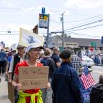 Demonstrators hold signs at the protest on Vashon. (Alex Bruell photo)