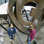 Julie Speidel stands next to one of her monumental sculptures during its fabrication in Seattle in 2017. (GeekWire/Kurt Schlosser Photo)