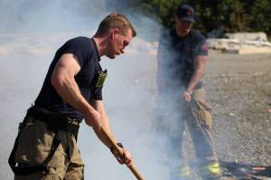 Vashon Island Fire & Rescue crews extinguish a small beach fire during the countys burn ban on the morning of Aug. 3, 2024. (Alex Bruell photo)