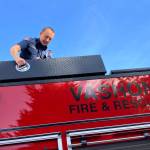 Lieutenant/Acting Captain Brad John, atop Vashon Island Fire & Rescues newest fire engine. (Elizabeth Shepherd photo)