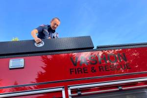 Lieutenant/Acting Captain Brad John, atop Vashon Island Fire & Rescues newest fire engine. (Elizabeth Shepherd photo)