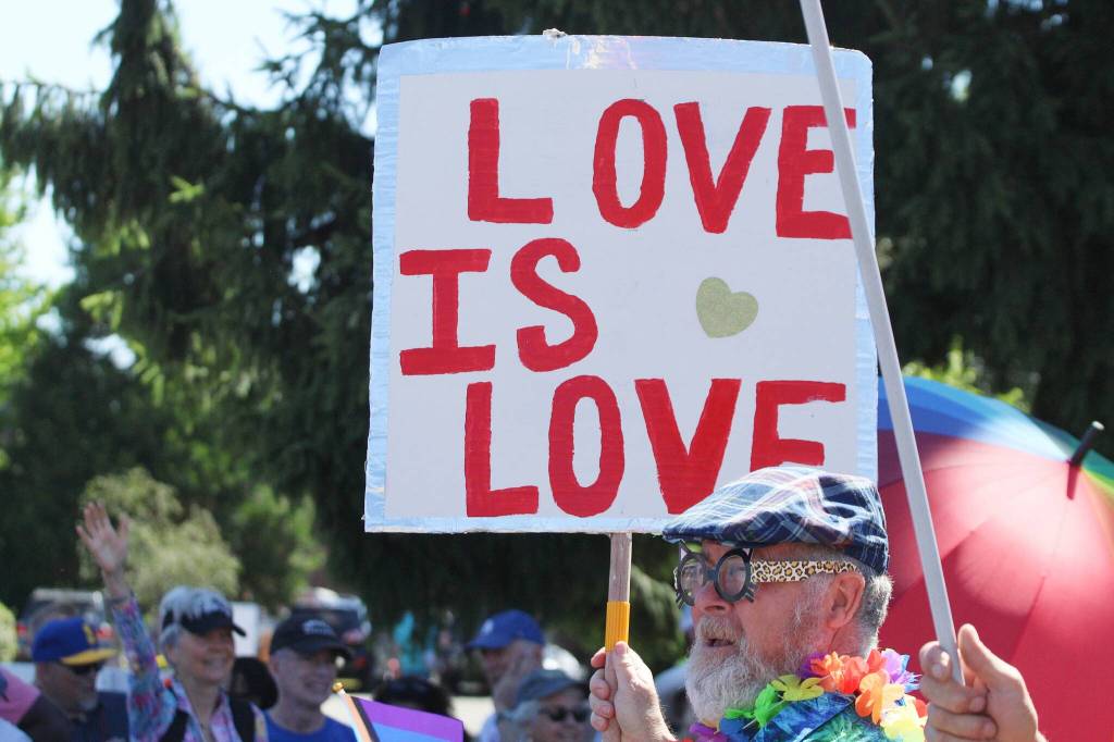 A sign reads Love is Love at the 2024 Strawberry Festival parade. (Alex Bruell photo)