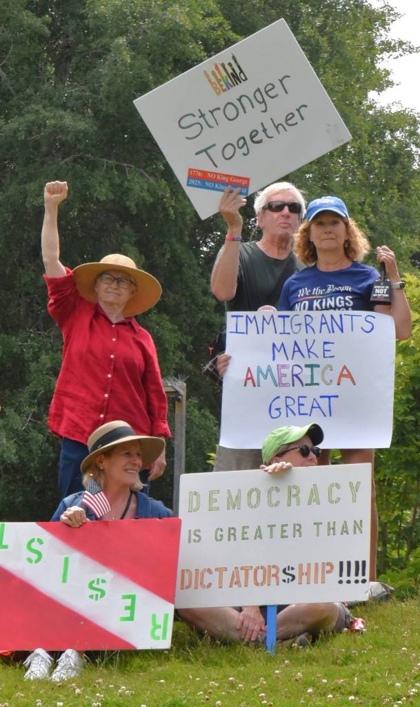 These islanders gathered with 100 more in Ober Park and then marched through town to protest actions of the Trump administration. (Jim Diers photo)