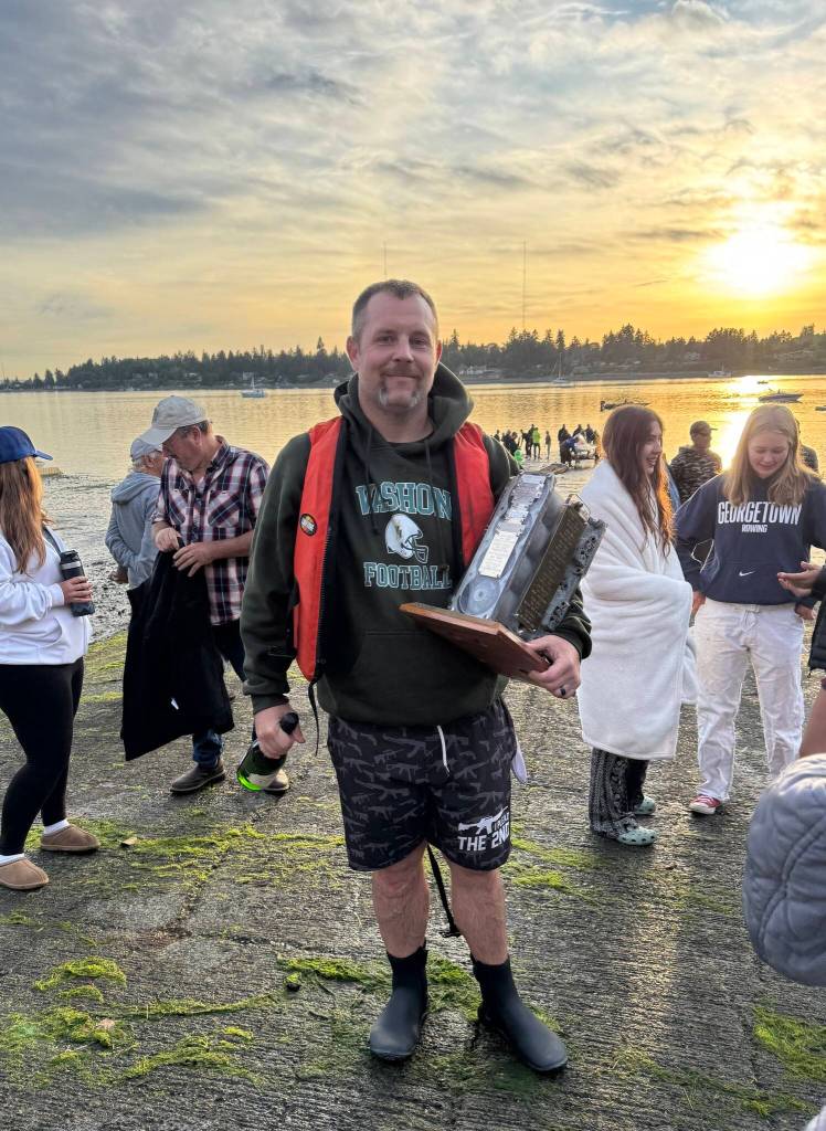 Winner Jake Middling claimed possession of the perpetual trophy for Vashons annual Fourth of July hydroplane race. (Brian Brenno photo)