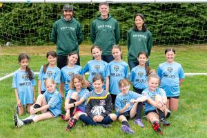 The W.O. Man City team from left to right, including (back row/coaches): Devin Branson, Brad Claus and Nicole Tadano; (middle row) Violet Provo, Dakota Branson, Clara Langland, Cora Banducci, Mia Doyle, Sierra Stein and Blake Smith; and (front row) Arden Arthur, Gwen Buse, Joss Moe, Vivian Claus and Isla Peterson. (Jonathan Stein photo)