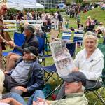 At Ober Park, an islander consulted her copy of The Beachcomber festival guide to decide her next festival destination. (Elizabeth Shepherd photo)
