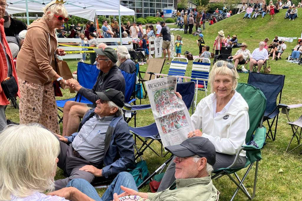 At Ober Park, an islander consulted her copy of The Beachcomber festival guide to decide her next festival destination. (Elizabeth Shepherd photo)