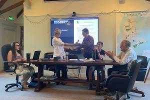 Diane Emerson, former Vashon-Maury Island Community Council president hands the gavel over to her successor, JC Graham, at the council meeting on July 17. (Mari Kanagy photo)