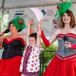 The irrepressible and glamorous Washington State Fairies Tami Brockway Joyce (left) and Jennifer Potter proclaim TK Rose as the islands new Unofficial Mayor. The Fairies emceed the Festivals Main Stage on Saturday. (Alex Bruell photo)