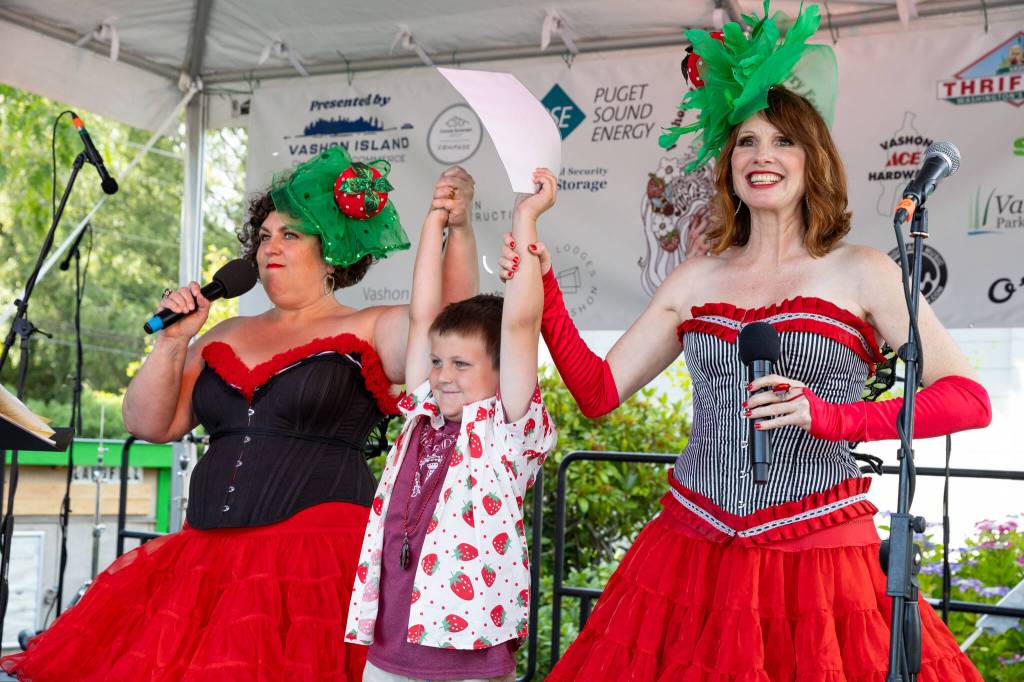 The irrepressible and glamorous Washington State Fairies Tami Brockway Joyce (left) and Jennifer Potter proclaim TK Rose as the islands new Unofficial Mayor. The Fairies emceed the Festivals Main Stage on Saturday. (Alex Bruell photo)