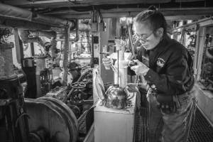 Aboard the Virginia V wooden steamship, volunteer engineer Lydia Louie prepares an oiler in the engine room on a Vashon Heritage Museum tour. (Terry Donnelly photo)