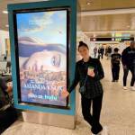 Amanda Knox spots a poster for The Twisted Tale of Amanda Knox at Sea-Tac Airport. (Courtesy photo)