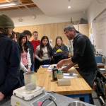 Vashon High School jewelry and chemistry students gather around Dr. Joshua Marceau as he discusses metallurgy. (Courtesy Photo)