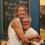 Carrie Van Buren and Nancy Katica share a hug at Vashon Bookshop. (Phil Clapham Photo)