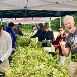 Brian Thiel of Ghostfish Brewing, in right foreground, celebrates at a harvest party. (James Cottrell Photo)