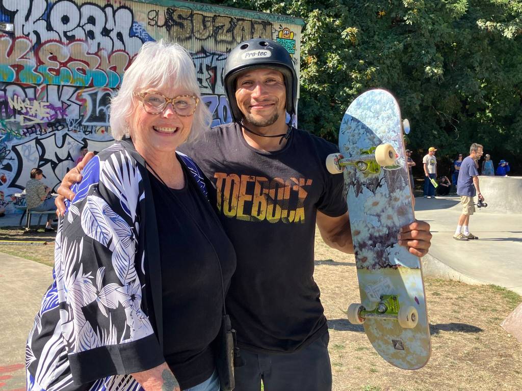 Judith Neary, seen here with a happy skater, was all smiles at Attack the Track. (Elizabeth Shepherd Photo)
