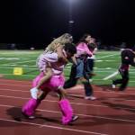 Royalty race on the sidelines during halftime. (Tom Hughes)
