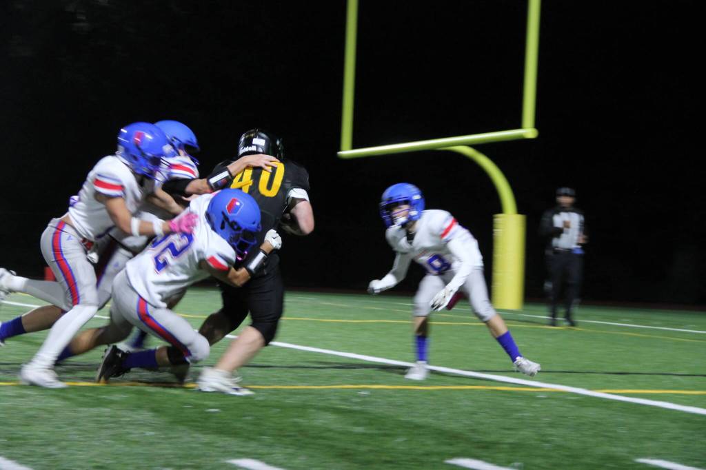 Senior Tallis Sullivan practically carrying three Vikings on his back as he crossed the goal line to score for the Pirates in the homecoming game. (Tom Hughes Photo)