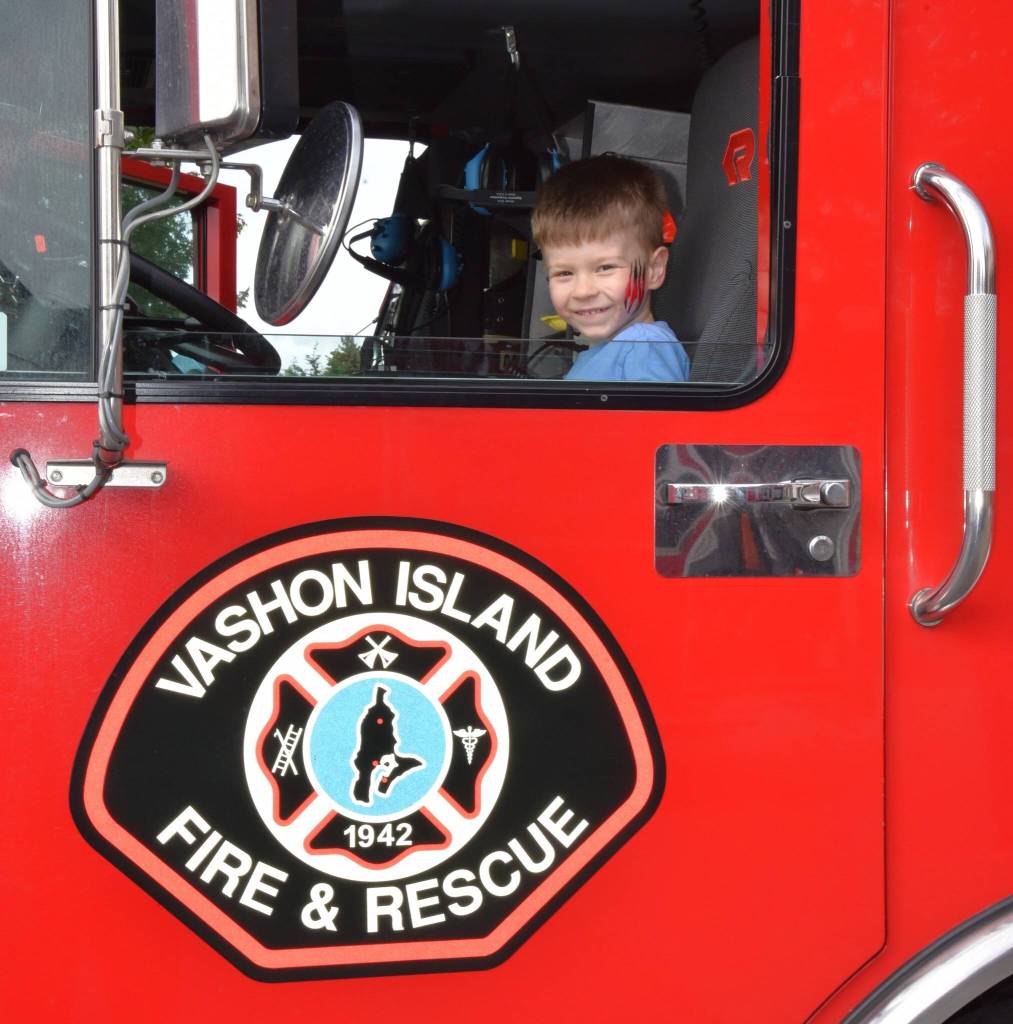 At VIFRs open house, local photographer Jim Diers captured the joy on his grandsons face as he sat in the drivers seat of a fire truck. (Jim Diers Photo)
