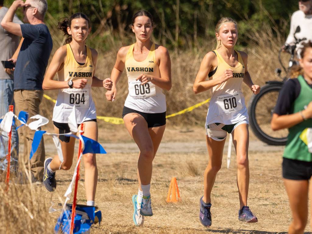 From left, Vashon High School runners Emily Harrington, Cece Guenther and Annabelle Thompson compete in the girls varsity race at the Fort Steilacoom Invitational. (John Decker Photo)