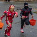 Kids rush to the Vashon Chamber of Commerce to collect candy on Halloween night, 2024. As is traditional on Vashon, Vashon Highway will once again close to traffic between Ober Park and Vashon Theatre from 5-8 p.m. on Halloween. (Alex Bruell Photo)