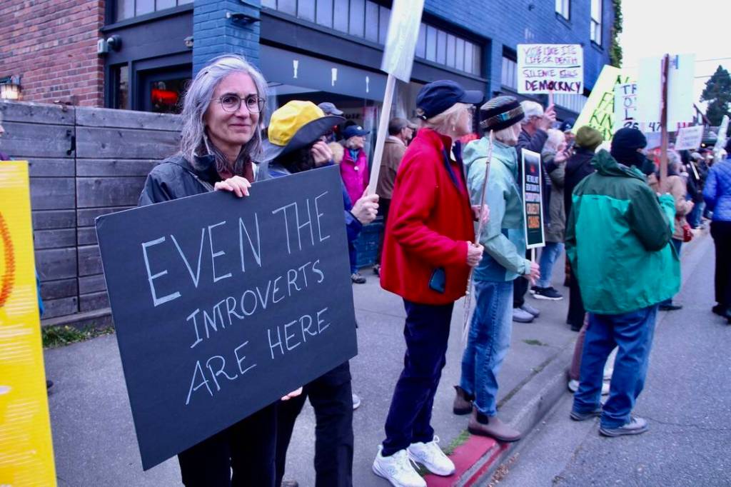 An introvert at the protest manages a slight smile for the camera. (Tom Hughes Photo)