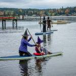Participants paddle through gray skies and light rain at Jensen Point, keeping the islands witchy Halloween tradition afloat. (Kent Phelan Photo)